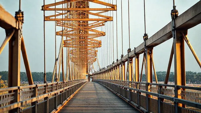 Photorealistic, professional photography, 8K, cinematic lighting, sharp focus, depth of field, shot on a high-end DSLR. A sturdy, elegant bridge constructed with strong, traditional materials, but featuring clearly visible, modern expansion joints and flexible connectors that allow for subtle movement and adaptation to environmental shifts. The lighting is strong, highlighting the blend of rigidity and flexibility. The scene conveys robust engineering and smart adaptation. Photorealistic, professional photography, 8K, cinematic lighting, sharp focus, depth of field, shot on a high-end DSLR. A sturdy, elegant bridge constructed with strong, traditional materials, but featuring clearly visible, modern expansion joints and flexible connectors that allow for subtle movement and adaptation to environmental shifts. The lighting is strong, highlighting the blend of rigidity and flexibility. The scene conveys robust engineering and smart adaptation.