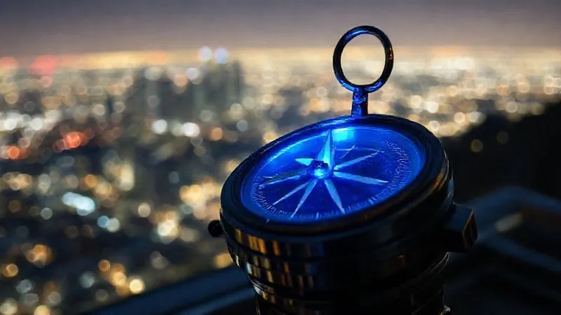 A photorealistic image of a futuristic compass glowing with a blue light, pointing towards a distant, shimmering horizon, with a blurred cityscape in the background. Professional photography, 8K, cinematic lighting, sharp focus on the compass, depth of field blurring the background, shot on a high-end DSLR.