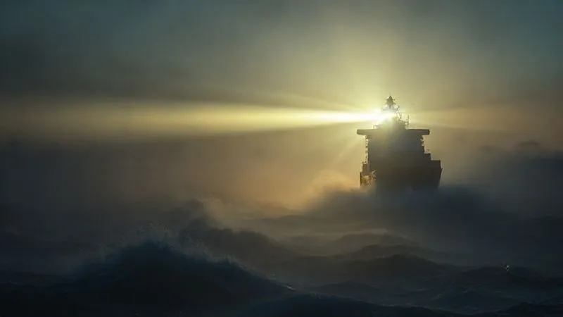A photorealistic image of a powerful lighthouse beam cutting through a turbulent, foggy sea at dawn, guiding a modern cargo ship safely towards a distant, clear horizon. The light is sharp and focused, symbolizing clarity and vision amidst urgent change. professional photography, 8K, cinematic lighting, sharp focus, depth of field, shot on a high-end DSLR. A photorealistic image of a powerful lighthouse beam cutting through a turbulent, foggy sea at dawn, guiding a modern cargo ship safely towards a distant, clear horizon. The light is sharp and focused, symbolizing clarity and vision amidst urgent change. professional photography, 8K, cinematic lighting, sharp focus, depth of field, shot on a high-end DSLR.