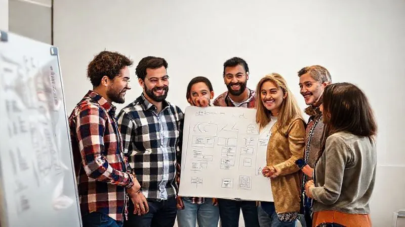 A photorealistic image of a diverse project team gathered around a whiteboard, actively collaborating and brainstorming solutions with positive and determined expressions. The atmosphere is one of focused teamwork and renewed energy, with bright, professional lighting. Professional photography, 8K, cinematic lighting, sharp focus, depth of field.