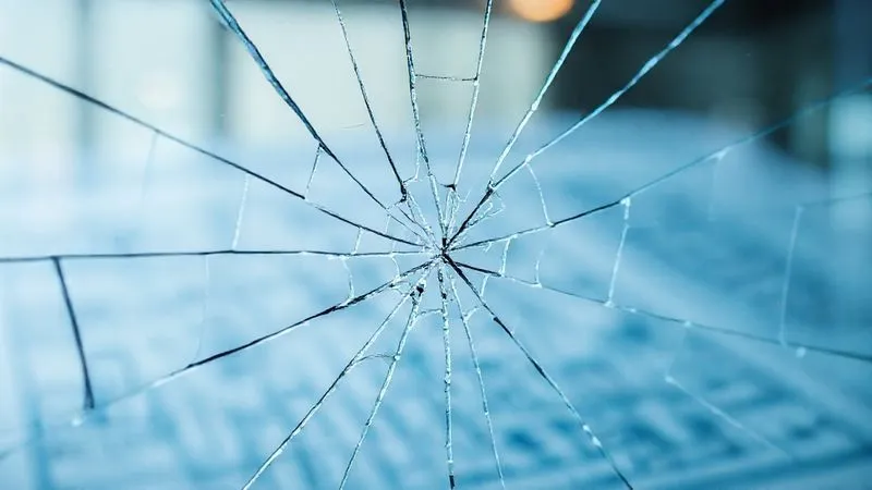 A photorealistic image of a cracked glass pane with a project blueprint visible underneath, symbolizing broken trust in a professional context. Cinematic lighting, sharp focus on the cracks, depth of field. 8K hyper-detailed, professional photography, shot on a high-end DSLR.